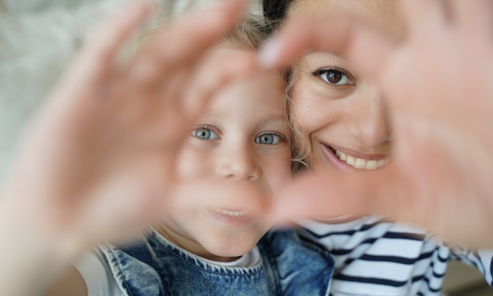 Smiling Foster Mom, Adopted Child Girl Daughter Taking Selfie, Showing Love Heart Gesture Together