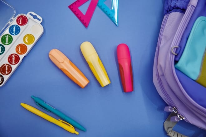 Backpack With Colorful School Supplies Flat Lay On Blue Background